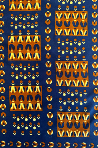 Vintage small figure printed scarf in deep navy blue with orange and yellow pattern of tulip-shaped repeating figures in rectangular blocks. 