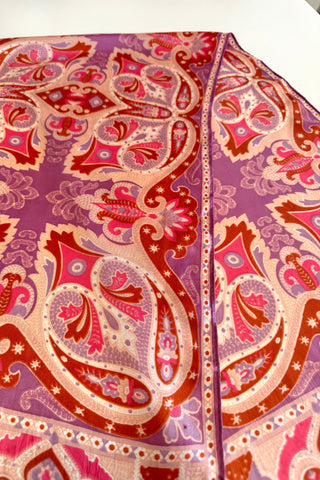 Swirling psychedelic print 1960s vintage scarf in shades of pink, purple, brown, and cream. Flowers, starbursts, paisley and other intricate shapes curve together in perfect harmony on this bright twill scarf.  