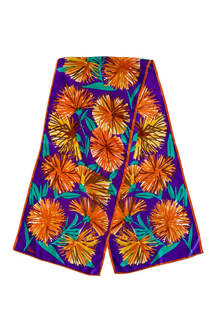 Long, rectangular vintage silk scarf by Vera, with royal purple background and bold orange and green dandelion print. 