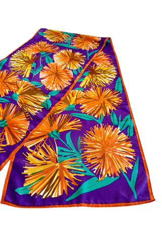 Long, rectangular vintage silk scarf by Vera, with royal purple background and bold orange and green dandelion print. 