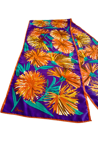 Long, rectangular vintage silk scarf by Vera, with royal purple background and bold orange and green dandelion print. 