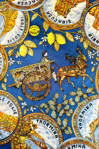 Richly detailed vintage souvenir scarf from Sicily, featuring illustrations of famous sights of several Sicilian cities, along with botanical illustrations and depictions of traditional Sicilian dress and design.