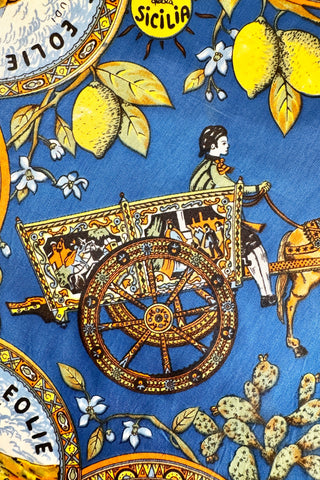 Richly detailed vintage souvenir scarf from Sicily, featuring illustrations of famous sights of several Sicilian cities, along with botanical illustrations and depictions of traditional Sicilian dress and design.