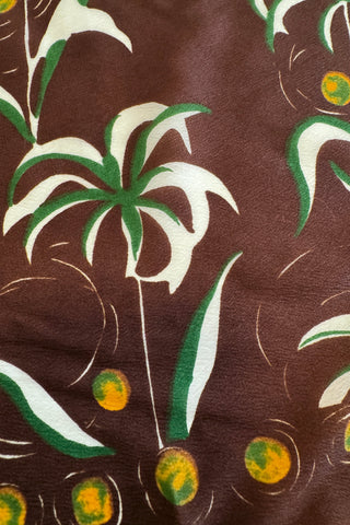 Deep brown 1950s vintage scarf with stylized palm tree print with yellow coconut border.