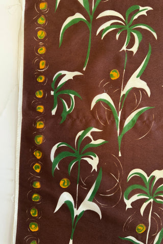 Deep brown 1950s vintage scarf with stylized palm tree print with yellow coconut border.