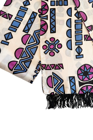 Long white vintage evening scarf with black fringed ends, featuring a collection of bold geometric shapes in shades of pigeon blue, plum purple and black. 