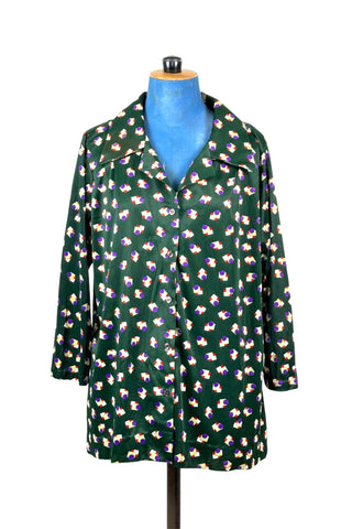 Deep emerald green vintage 1970s button down shirt with pointed collar and three-quarter length sleeves. The nylon polyester fabric features a geometric pattern with white, yellow, and red squares with purple circles.