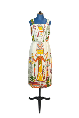 Incredible vintage 1960s sheath dress with giant Native American Kachina doll and cactus motif on medium-weight cotton. The top of the bodice is finished with cream piping. The skirt is lined in beige acetate, while the bodice is unlined. Closes with a nylon zipper.