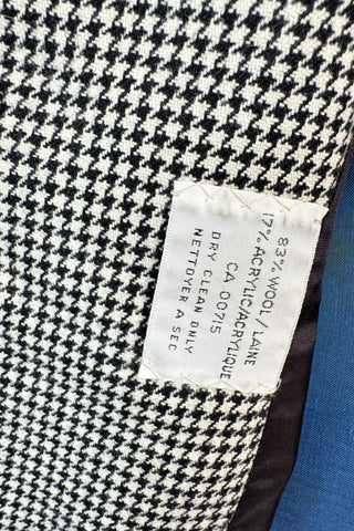 Super-chic nipped waist vintage 1970s blazer in black and white houndstooth wool. Designed by Lily Simon, who was a fixture of Montreal fashion in the 1950s, 1960s and 1970s with her famous store on Saint-Laurent Boulevard. Originally, the shop curated a collection of high-end clothing from local designers, then eventually expanded to sell internationally renowned couture brands. This blazer is from Lily Simon’s own couture-quality collection.