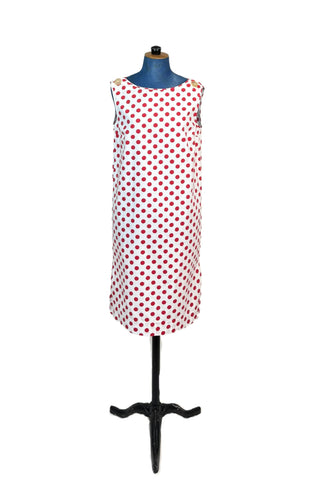 Vintage 1960s polka dot dress in 100% cotton. The plain weave cotton features a large red polka dot print on a white background. Oversized buttons at the shoulder add to the whimsy of this fun mod dress. Wear belted for a more fitted look, or unbelted to frolic, wild and free.