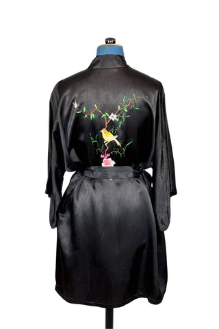 Vintage kimono-style 1950s robe in silky black rayon, embroidered with flowers on each pocket and a charming yellow bird and floral branch on the back.