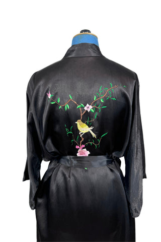 Vintage kimono-style 1950s robe in silky black rayon, embroidered with flowers on each pocket and a charming yellow bird and floral branch on the back.