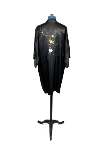 Vintage kimono-style 1950s robe in silky black rayon, embroidered with flowers on each pocket and a charming yellow bird and floral branch on the back.