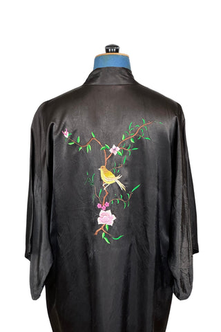 Vintage kimono-style 1950s robe in silky black rayon, embroidered with flowers on each pocket and a charming yellow bird and floral branch on the back.