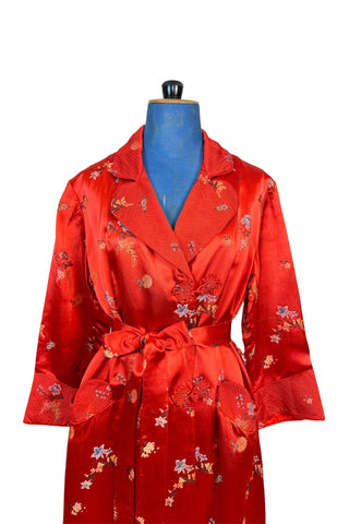 Vintage 1950s robe in rich, heavy rayon Chinese brocade. The collar, cuffs, and pockets are intricately quilted, which adds beautiful structure and weight in those areas. Closes in the front with two frog closures, and ties with a matching sash belt. Fully lined in silky red rayon.  