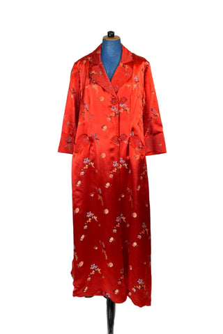 Vintage 1950s robe in rich, heavy rayon Chinese brocade. The collar, cuffs, and pockets are intricately quilted, which adds beautiful structure and weight in those areas. Closes in the front with two frog closures, and ties with a matching sash belt. Fully lined in silky red rayon.  