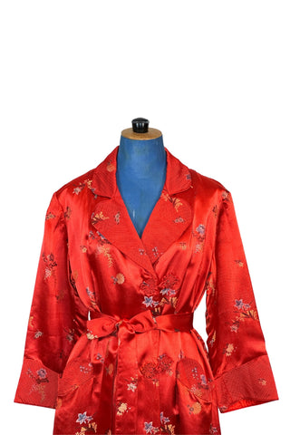 Vintage 1950s robe in rich, heavy rayon Chinese brocade. The collar, cuffs, and pockets are intricately quilted, which adds beautiful structure and weight in those areas. Closes in the front with two frog closures, and ties with a matching sash belt. Fully lined in silky red rayon.  