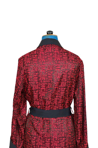 Suave vintage 1970s smoking jacket by Majestic in red and black patterned acetate (the collar, cuffs, and belt seem to be rayon faille, although the tag says 100% acetate - this may not include the trim). Slip into this beauty after a long day and let the mellowing out begin. 