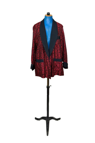 Suave vintage 1970s smoking jacket by Majestic in red and black patterned acetate (the collar, cuffs, and belt seem to be rayon faille, although the tag says 100% acetate - this may not include the trim). Slip into this beauty after a long day and let the mellowing out begin. 