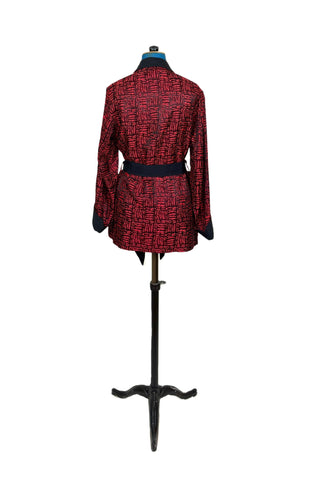 Suave vintage 1970s smoking jacket by Majestic in red and black patterned acetate (the collar, cuffs, and belt seem to be rayon faille, although the tag says 100% acetate - this may not include the trim). Slip into this beauty after a long day and let the mellowing out begin. 