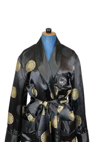 Rich, heavy rayon vintage 1940s robe of black and gold Chinese brocade. The brocade design features intricate gold and black medallions. The chest pocket is embroidered with a charming landscape scene. Fully lined in soft black rayon. Marked size 42. 