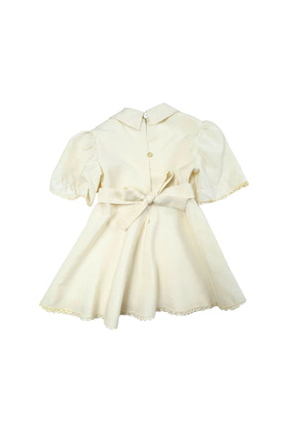 This darling vintage 1960s cape and dress set is embroidered with pink cherry blossoms and pink, blue and yellow tulips. The cape has a detachable hood which attaches with buttons at the back and sides of the cape’s round Peter Pan collar. The collar and hem of the cape are trimmed with scalloped crocheted lace. The cape has a double-breasted front closure with white and silver tone square buttons. There are arm holes in the middle of the front seams.