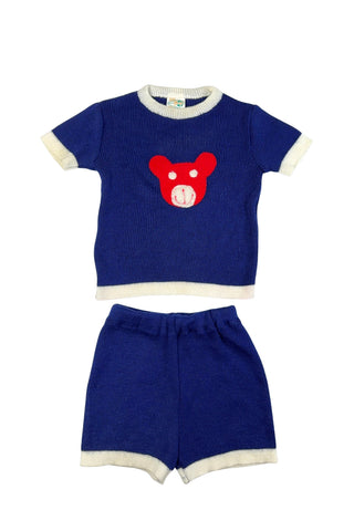 Vintage 1960s children’s knit set of short sleeve sweater and elastic waist shorts. The collar, cuffs, and hems of the sweater and shorts have a contrasting cream band.
The sweater is marked size 4, while the shorts are size 6.