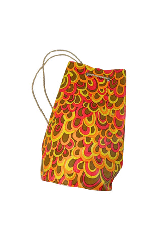 Cute little vintage 1960s waterproof bag for the beach or poolside. The tube-shaped bag closes with a drawstring cord which goes through grommets in the top and bottom of the bag.