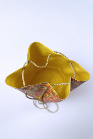 Cute little vintage 1960s waterproof bag for the beach or poolside. The tube-shaped bag closes with a drawstring cord which goes through grommets in the top and bottom of the bag.