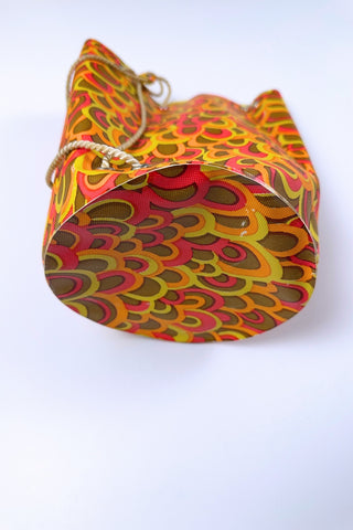 Cute little vintage 1960s waterproof bag for the beach or poolside. The tube-shaped bag closes with a drawstring cord which goes through grommets in the top and bottom of the bag.