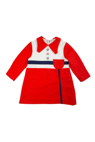 Vintage 1970s children’s dress with red skirt and sleeves, white bodice, and red pointed collar and matching pocket. The bodice and skirt feature contrasting navy blue stripes vertically and horizontally. Three decorative buttons at the neck finish this perfect late-mod look. The dress closes with a metal zipper in the back, and is fully lined in dove grey rayon.