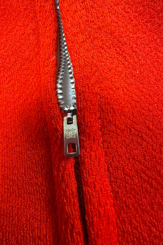 Vintage 1970s children’s dress with red skirt and sleeves, white bodice, and red pointed collar and matching pocket. The bodice and skirt feature contrasting navy blue stripes vertically and horizontally. Three decorative buttons at the neck finish this perfect late-mod look. The dress closes with a metal zipper in the back, and is fully lined in dove grey rayon.