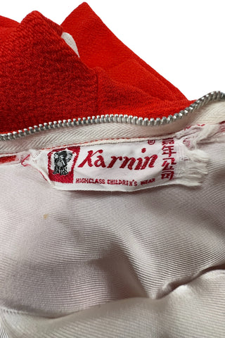 Vintage 1970s children’s dress with red skirt and sleeves, white bodice, and red pointed collar and matching pocket. The bodice and skirt feature contrasting navy blue stripes vertically and horizontally. Three decorative buttons at the neck finish this perfect late-mod look. The dress closes with a metal zipper in the back, and is fully lined in dove grey rayon.