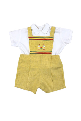 Vintage toddler’s two piece set of embroidered yellow overalls and crisp white blouse. The bib of the overalls is decorated with red, green, and yellow rickrack trim, and an embroidered scene with two tiny people wearing lederhosen outfits. The overalls have adjustable straps with two sets of buttons for two length options. The back of the waist is elasticized. The white blouse has a small pointed collar, a decorative folded faux-placket down the front, and closes with three buttons in the back.