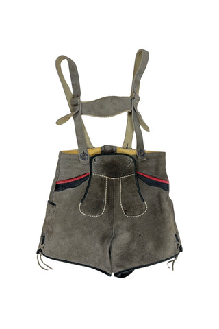 Vintage 1960s boys’ lederhosen in grey leather suede, with white scalloped suede trim, black leather accents and red suede piping.
The straps have metal buckle closures at the chest, and attach to the shorts with buttons (the shorts may be worn without straps). The front of the shorts has a flap that closes with two buttons at the waist.
In good vintage condition, with normal wear to the suede consistent with age. The inside of the front panel has a faux leather (vinyl) lining, where the vinyl has...