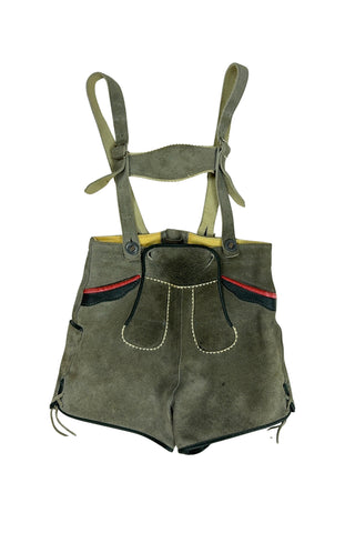Vintage 1960s boys’ lederhosen in grey leather suede, with white scalloped suede trim, black leather accents and red suede piping.
The straps have metal buckle closures at the chest, and attach to the shorts with buttons (the shorts may be worn without straps). The front of the shorts has a flap that closes with two buttons at the waist.
In good vintage condition, with normal wear to the suede consistent with age. The inside of the front panel has a faux leather (vinyl) lining, where the vinyl has...