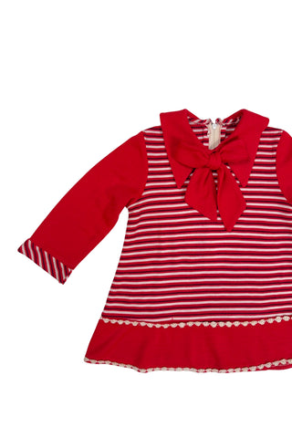 Vintage 1970s toddler dress in red, white, and black striped jersey, with a large pointed collar and oversized bow tie. The long sleeves, collar, and bottom panel of the skirt are solid red. The skirt is trimmed with daisy chain lace.

Crafted from a cotton/acrylic blend. The dress is unlined, and closes in the back with a cotton twill zipper.

Marked size 18 (months).