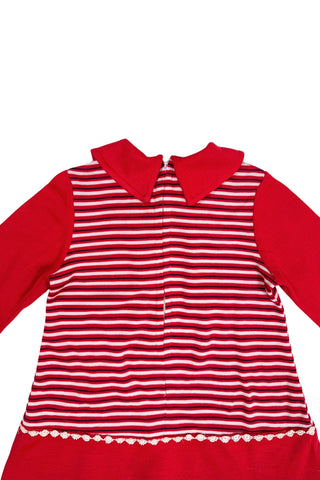 Vintage 1970s toddler dress in red, white, and black striped jersey, with a large pointed collar and oversized bow tie. The long sleeves, collar, and bottom panel of the skirt are solid red. The skirt is trimmed with daisy chain lace.

Crafted from a cotton/acrylic blend. The dress is unlined, and closes in the back with a cotton twill zipper.

Marked size 18 (months).