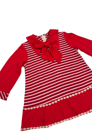 Vintage 1970s toddler dress in red, white, and black striped jersey, with a large pointed collar and oversized bow tie. The long sleeves, collar, and bottom panel of the skirt are solid red. The skirt is trimmed with daisy chain lace.

Crafted from a cotton/acrylic blend. The dress is unlined, and closes in the back with a cotton twill zipper.

Marked size 18 (months).