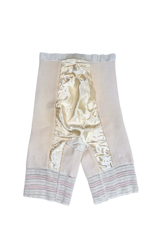 Vintage 1950s Bi-flex girdle shorts shaper garment with integrated stocking garters.

Crafted from mixed synthetic fabrics with a cotton smoother panel in the front to provide structure.

Inside the leg openings are stocking garter clips (hidden inside so that they don’t spoil the line of the garment).

The perfect base for all your true vintage or vintage inspired looks.

Designed by Bi-flex in Montreal, Canada.