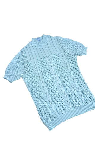 Vintage 1960s/1970s short sleeve sweater with an open eyelet knit pattern with vertical chevron panels and ribbed cuffs and collar. The back has a half-zipper closure. The material composition feels like a cotton/acrylic blend.