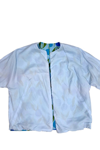 Vintage 1960s jacket in light blue cotton slub with a large tulip print. Features three-quarter length kimono-style sleeves, and an open front. Long darts from the bust to the waist provide shape through the torso. 

The lightweight jacket is lined in coordinating light blue rayon, which peeks through at the collar.