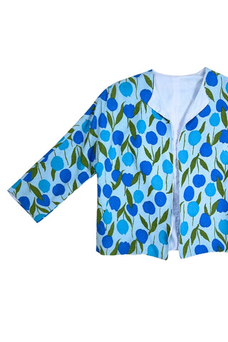Vintage 1960s jacket in light blue cotton slub with a large tulip print. Features three-quarter length kimono-style sleeves, and an open front. Long darts from the bust to the waist provide shape through the torso. 

The lightweight jacket is lined in coordinating light blue rayon, which peeks through at the collar.