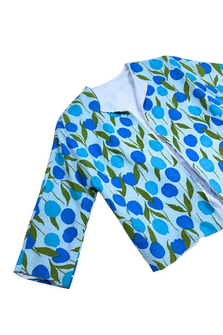 Vintage 1960s jacket in light blue cotton slub with a large tulip print. Features three-quarter length kimono-style sleeves, and an open front. Long darts from the bust to the waist provide shape through the torso. 

The lightweight jacket is lined in coordinating light blue rayon, which peeks through at the collar.