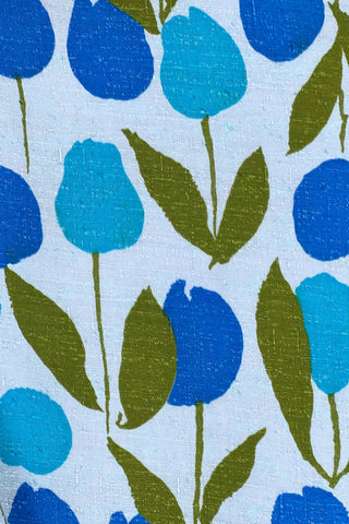 Vintage 1960s jacket in light blue cotton slub with a large tulip print. Features three-quarter length kimono-style sleeves, and an open front. Long darts from the bust to the waist provide shape through the torso. 

The lightweight jacket is lined in coordinating light blue rayon, which peeks through at the collar.
