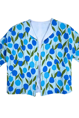 Vintage 1960s jacket in light blue cotton slub with a large tulip print. Features three-quarter length kimono-style sleeves, and an open front. Long darts from the bust to the waist provide shape through the torso. 

The lightweight jacket is lined in coordinating light blue rayon, which peeks through at the collar.