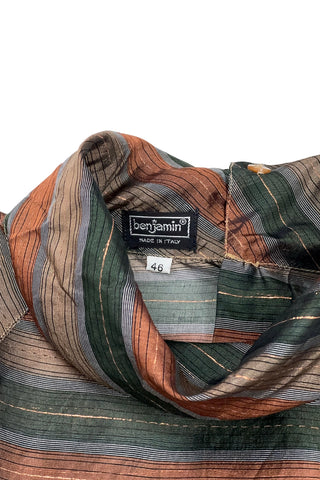 Vintage 70s/80s blouse in a sheer green, brown, and gold metallic striped rayon material. Features a folded scarf-like collar, long sleeves with buttoned cuffs, and closes with buttons down the back. 

Designed by Benjamin and Made in Italy. Marked size 46.