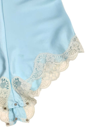 Vintage 1970s blue satin teddy one piece lingerie with snap closure by French Maid. Features beautiful wide white lace trim at the V neckline and around the legs, and matching blue satin spaghetti straps.

Designed by French Maid, Made in Canada. Marked Size 34.