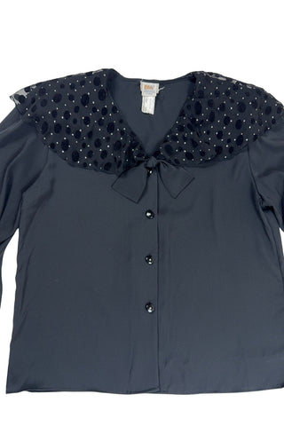 Vintage 1980s sheer black blouse with a chiffon collar featuring velvet polkadots and dots of silver sparkles. The blouse closes with four black buttons with rhinestone centres. The cuffs have matching button closures. The blouse comes with a separate tie piece that can be tied around the neck, or left off for a different look.