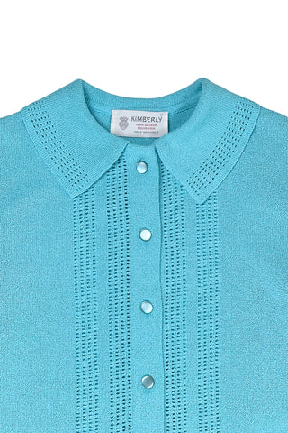 Vintage 1960s cardigan sweater in peacock blue Dacron polyester knit. The collar and button placket are accented with eyelet detailing. The cardigan closes with six pearly lucite buttons. 

The material is a medium weight polyester knit with a structured feel.

Designed by Kimberly.